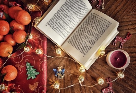 Libro rodeado de motivos de Navidad